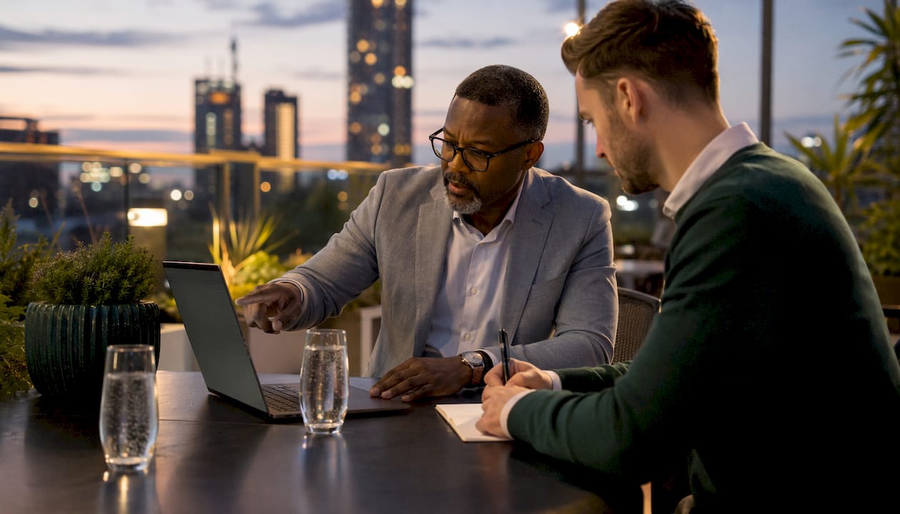 Two men discussing Mentimeter vs AhaSlides pricing
