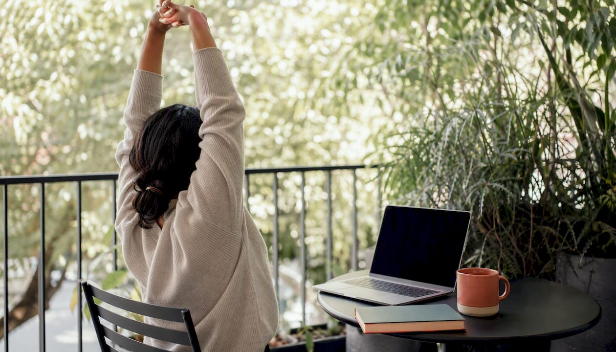 Arms performing desk yoga stretch